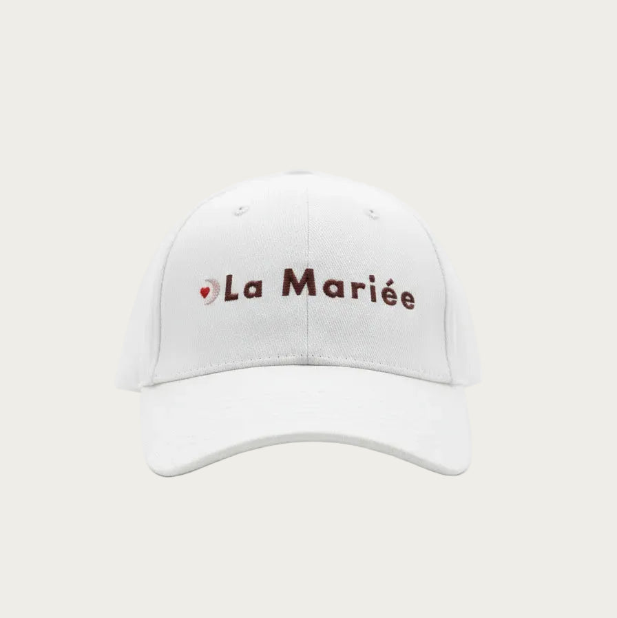Casquette blanche EVJF avec inscription ‘La Mariée’, accessoire festif pour la future mariée lors d’un enterrement de vie de jeune fille.