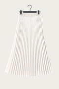 Jupe longue plissée blanche suspendue sur cintre, tenue élégante et fluide idéale pour un look EVJF chic.